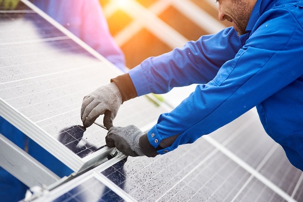 Person working on solar panels.
